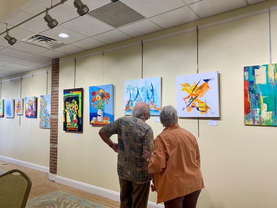 Residents at Cypress Village look at some of the artwork on display for the Spring Art Show, which was held Saturday, May 1.